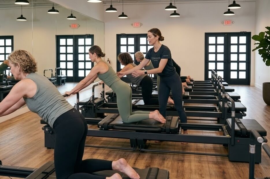 Group Pilates reformer class in professional fitness studio